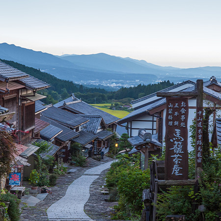 Stone-paved street in Magome-juku overlooking the mountains of Japan’s Kiso Valley